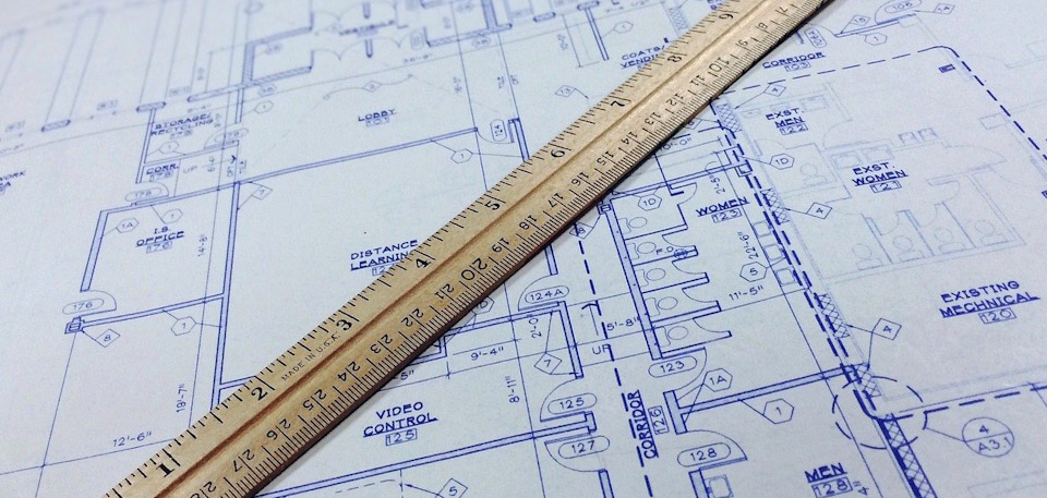 Blueprint architectural drawings with a ruler for remodel projects