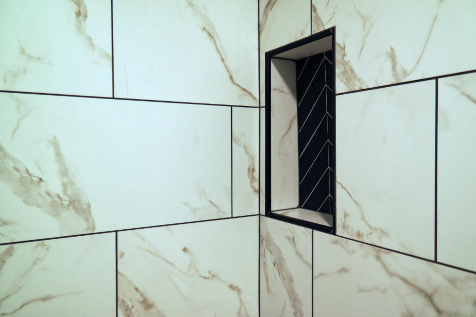 Custom marble tile shower wall shelf