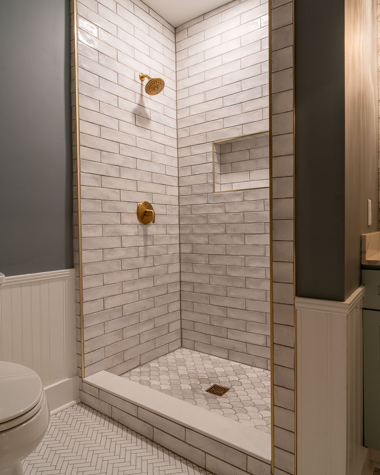 Beautiful custom tile shower with dramatic lighting